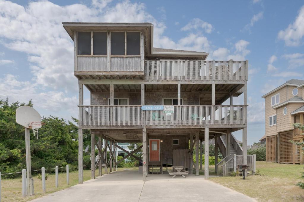a tall building with a balcony and a basketball hoop at 7651 - Sandrose in Avon