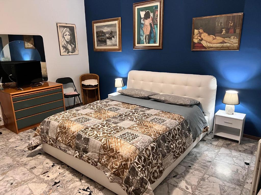 a bedroom with a king sized bed and a tv at Il Broletto B&B in Novara