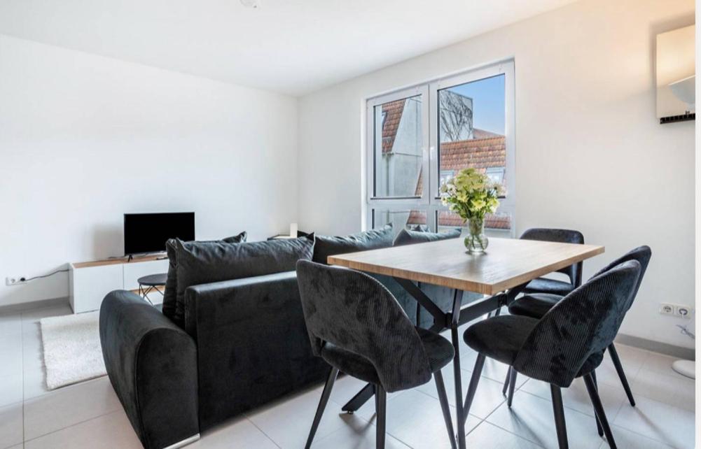 a living room with a couch and a table at Dom Central Suite in Greifswald