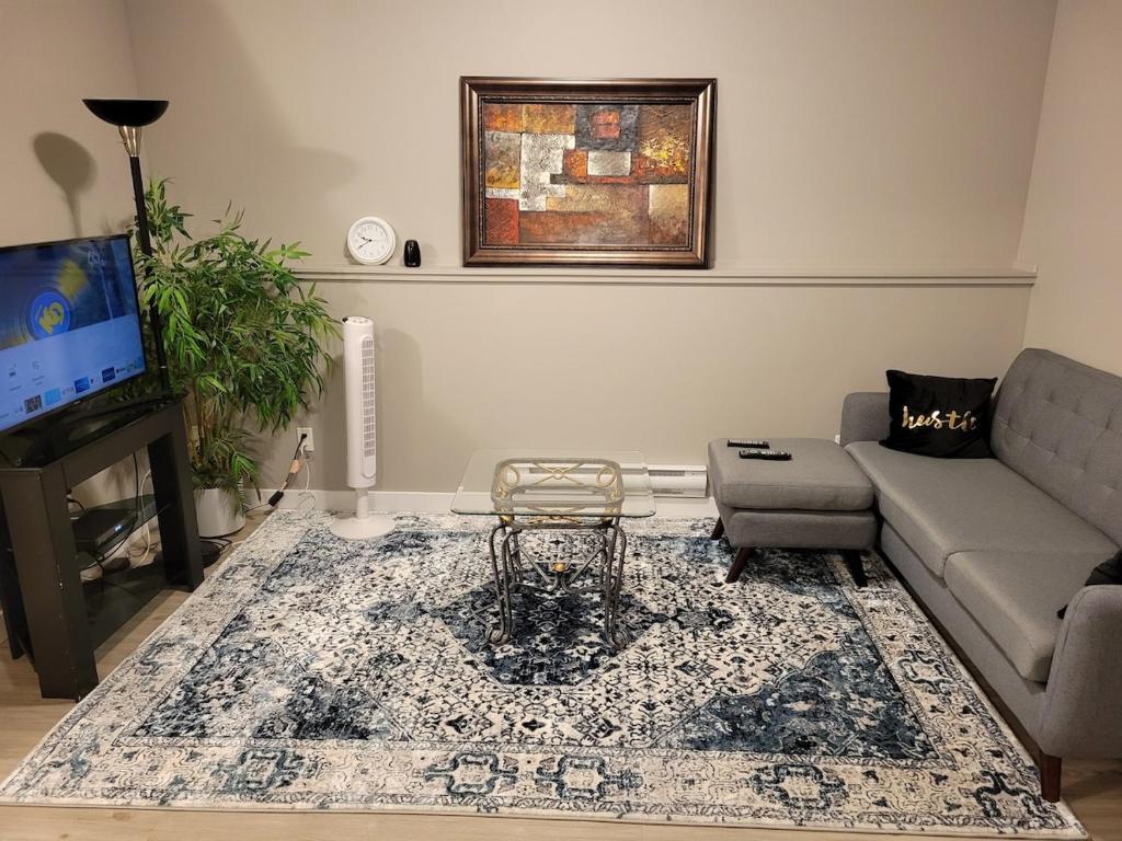 a living room with a couch and a table at Federal Palace in Saskatoon