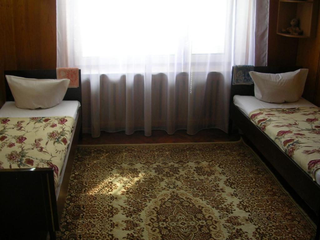 two beds sitting in a room with a window at Pilligrim in Kharkiv