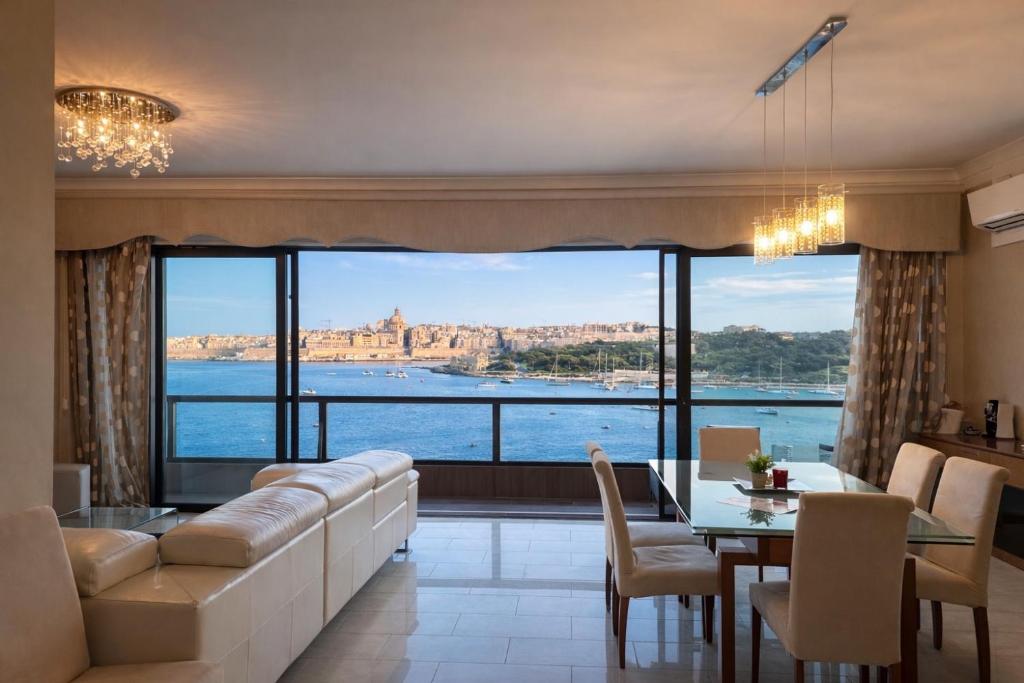 a living room with a couch and a table at Breathtaking Valletta Harbour View - Exclusive in Sliema