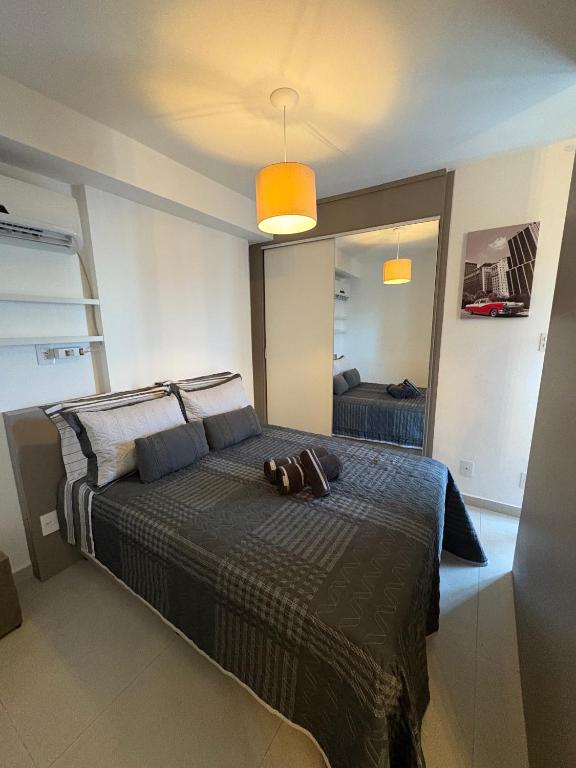 a bedroom with a bed with a purse on it at Studio completo com charme em ótima localização! in Juiz de Fora