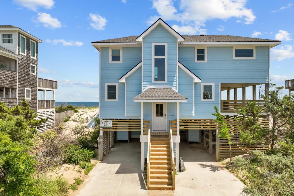 a blue house on the beach at 7675 - Sweet Caroline in Avon
