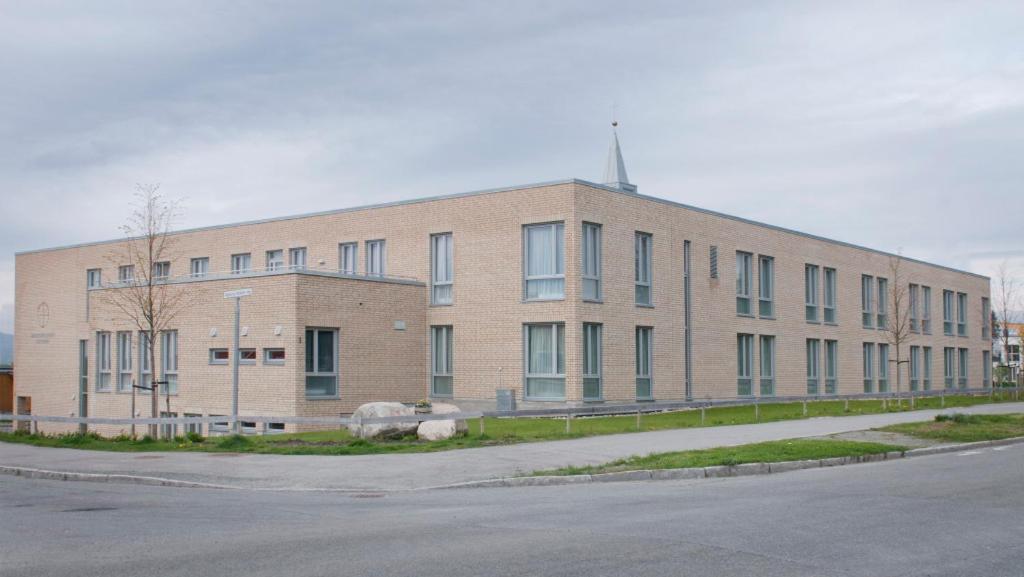 a large brick building on the side of a street at Birgittaklosteret i Trondheim in Trondheim