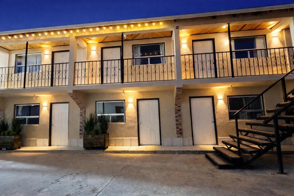 a building with white doors and lights on it at hotel Rarámuri in Creel