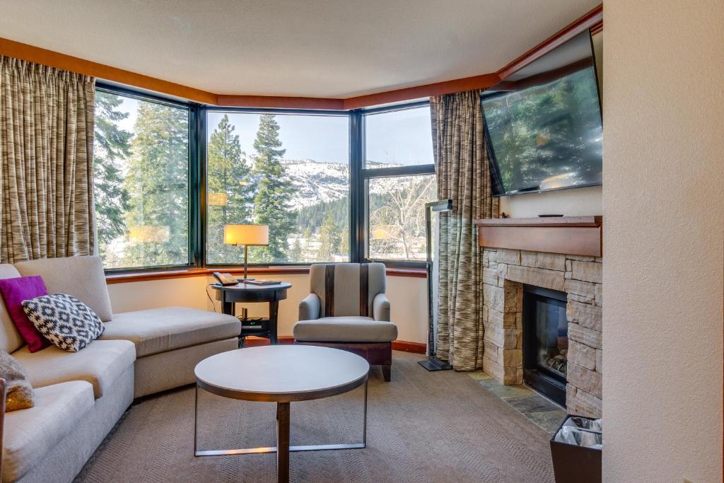 a living room with a couch and a fireplace at Everline Resort Suite: North Lake Tahoe Luxury! in Olympic Valley