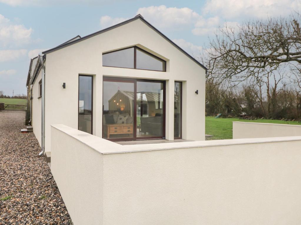 a small white house with a white fence at The Rookery in Greenfield Cross Roads