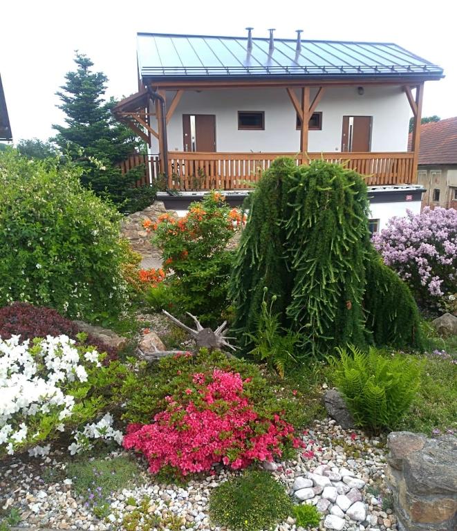 a garden with flowers in front of a house at Apartmány Kojčice in Kojčice
