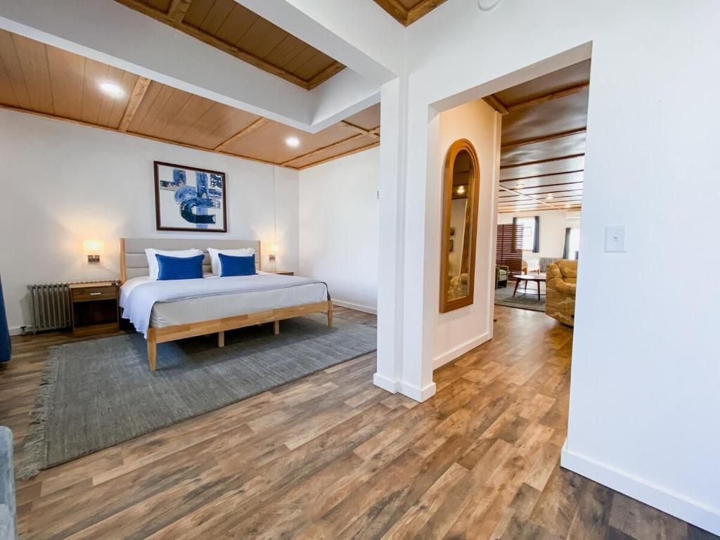a bedroom with a bed with blue pillows at Wilder Bunkhouse in De Smet