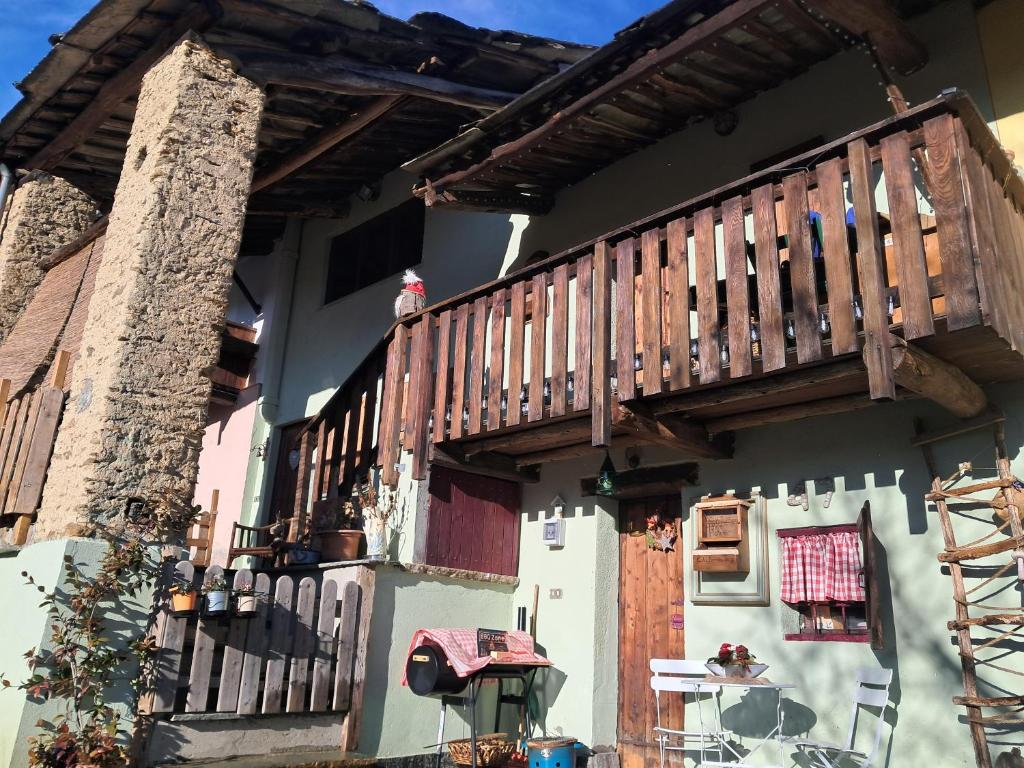 a house with a wooden deck on the side of it at Rifugio Felice in Bagnolo Piemonte