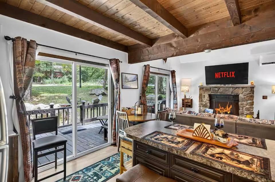 a living room with a desk and a fireplace at Hideout Pocono Chalet in Lake Ariel