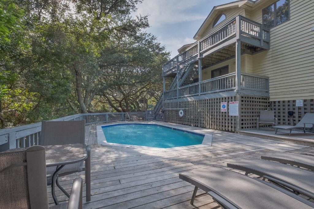 a house with a swimming pool on a wooden deck at 4603 - Yellow Brick Road in Southern Shores
