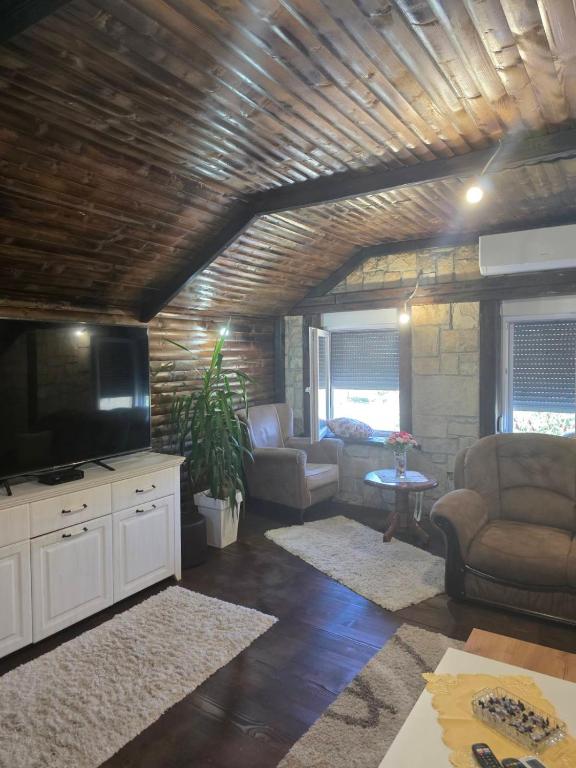 a living room with a flat screen tv and furniture at Vila Sopot lux in Risti°i