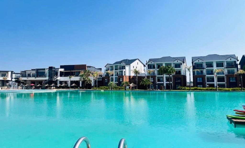 a large swimming pool with buildings in the background at Lagoon escape Apartment in Pretoria