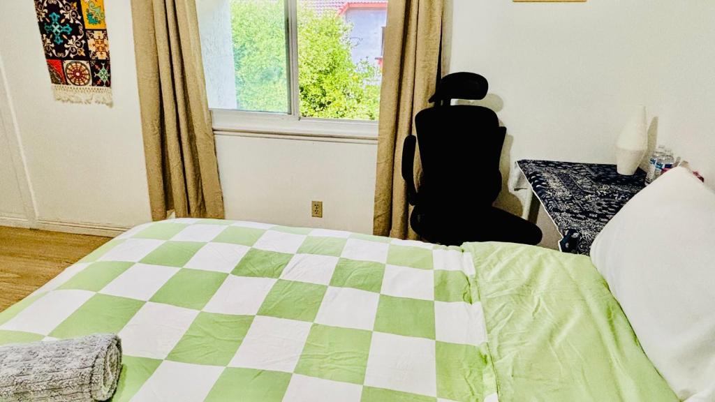 a bedroom with a bed and a window at Joshiehome in Rancho Cucamonga