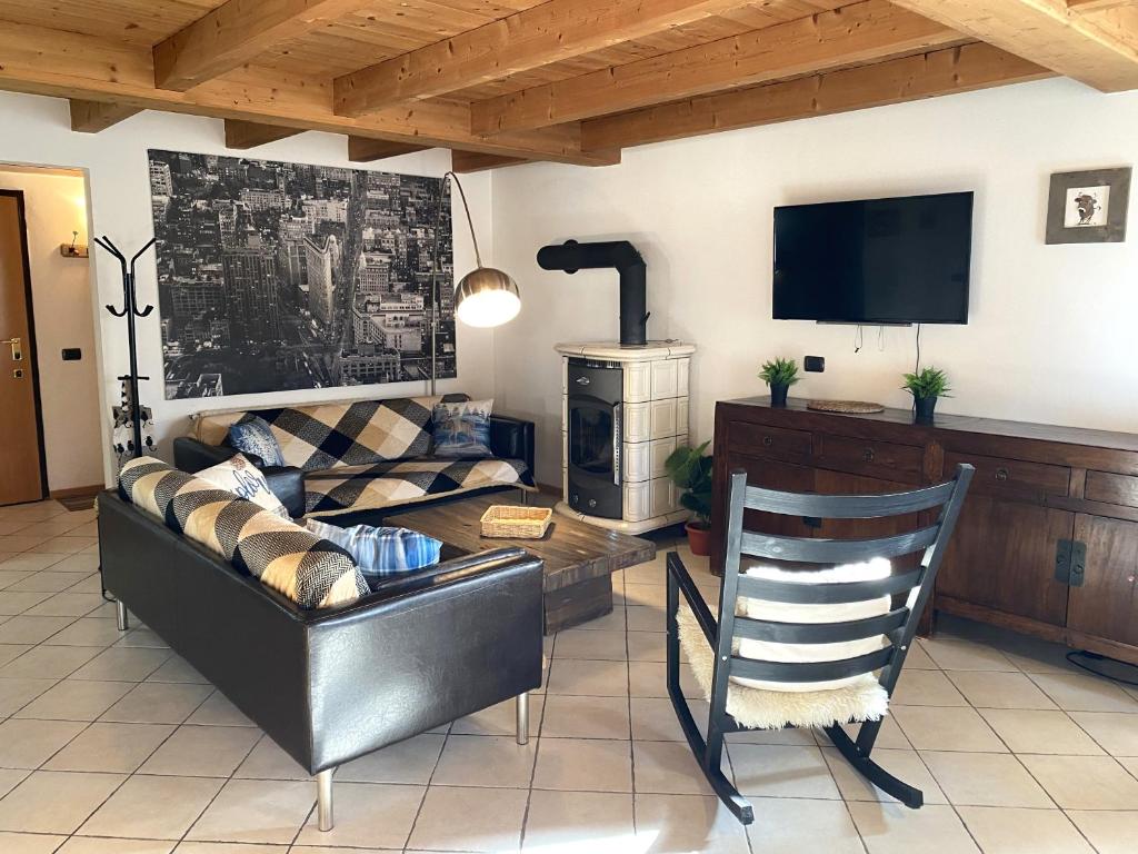 a living room with a couch and a television at My Sweet Home In The Dolomites - Casa LaLu in Cavalese