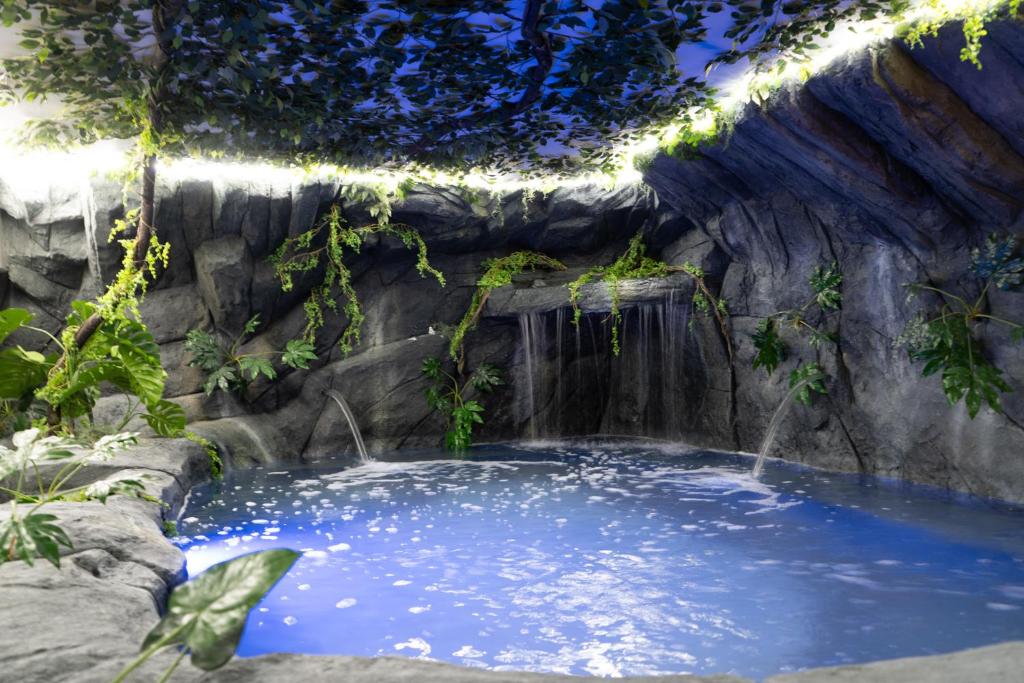 a large pool of water with a waterfall at Futurotel Space Spa Madrid Center in Madrid