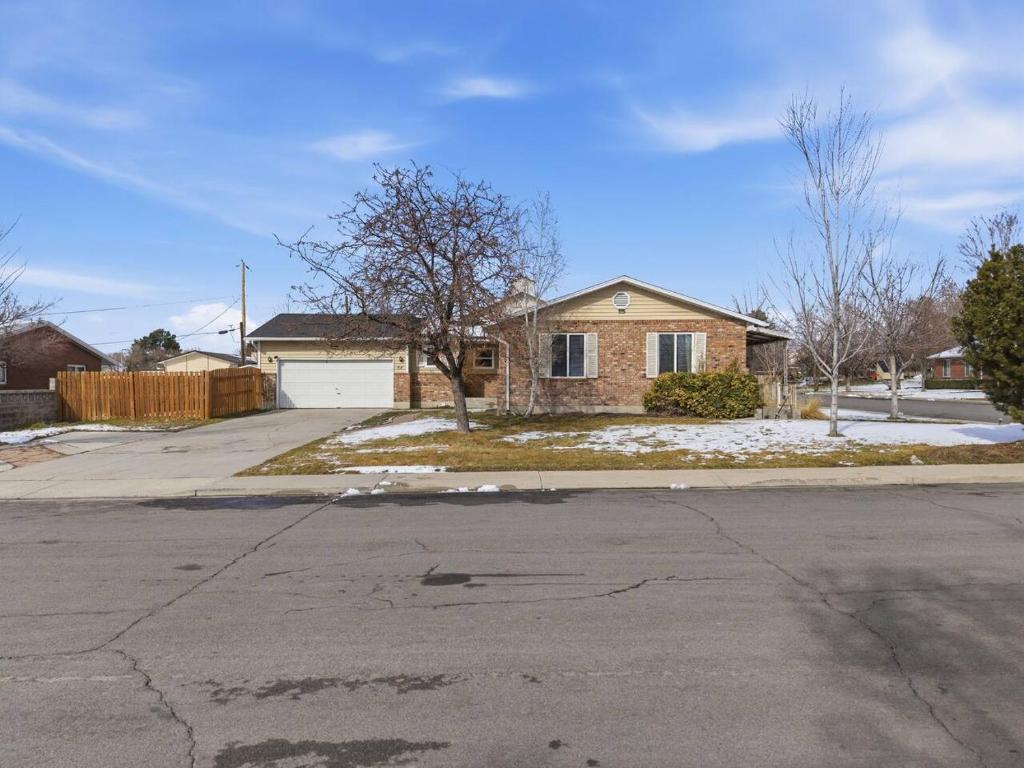 a house on a street with snow on the ground at Cozy Orem House - Playground - Game Rm - Bunk Rm in Orem