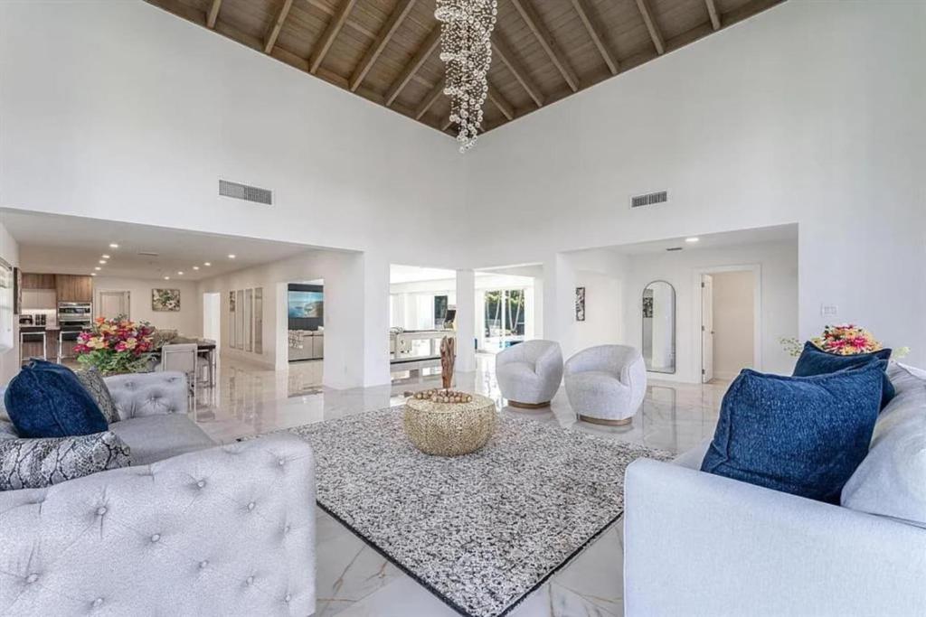 a living room with two couches and a table at Guest Fav | 5BR Pool Estate | Sleeps 16 in Palmetto Bay