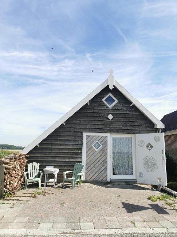 a small house with two chairs and a table at De Knol in Hoek
