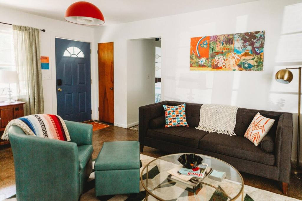 a living room with a couch and a glass table at Charming Cottage w Hot Tub in Myers Airport