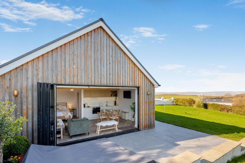 a barn style house with a large sliding glass door at 1 Bed in Llanmorlais oc-p35002 in Penclawdd