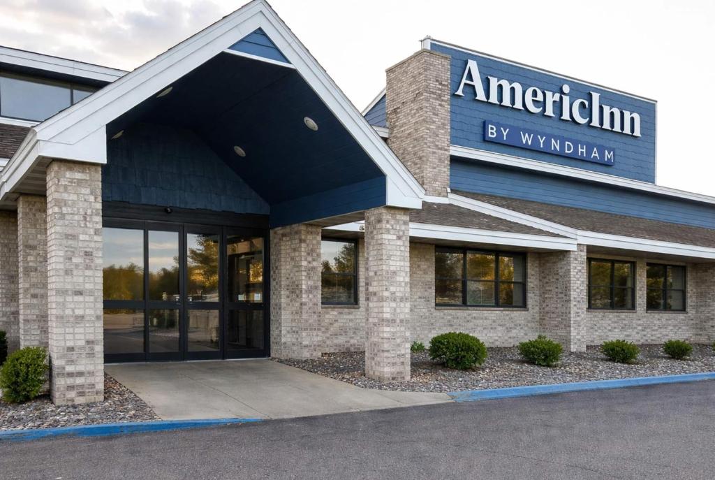an office building with a sign that reads american inn by walmart at AmericInn by Wyndham Fergus Falls Conference Center in Fergus Falls