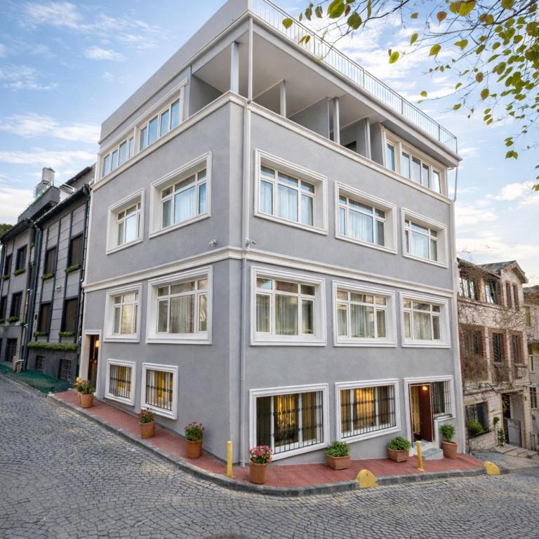 an apartment building with windows on a street at Emirhan Guesthouse & Suites in Istanbul