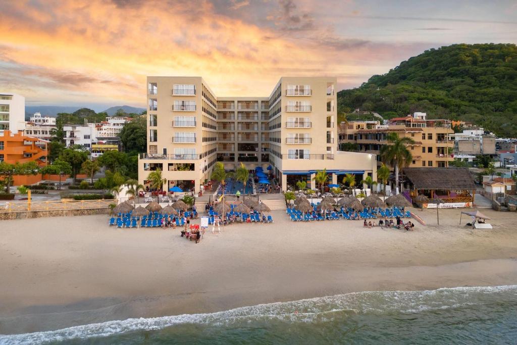 Luftaufnahme eines Strandes mit Liegestühlen und Gebäuden in der Unterkunft Decameron La Marina Guayabitos, Ramada All-Inclusive Resort in Rincón de Guayabitos