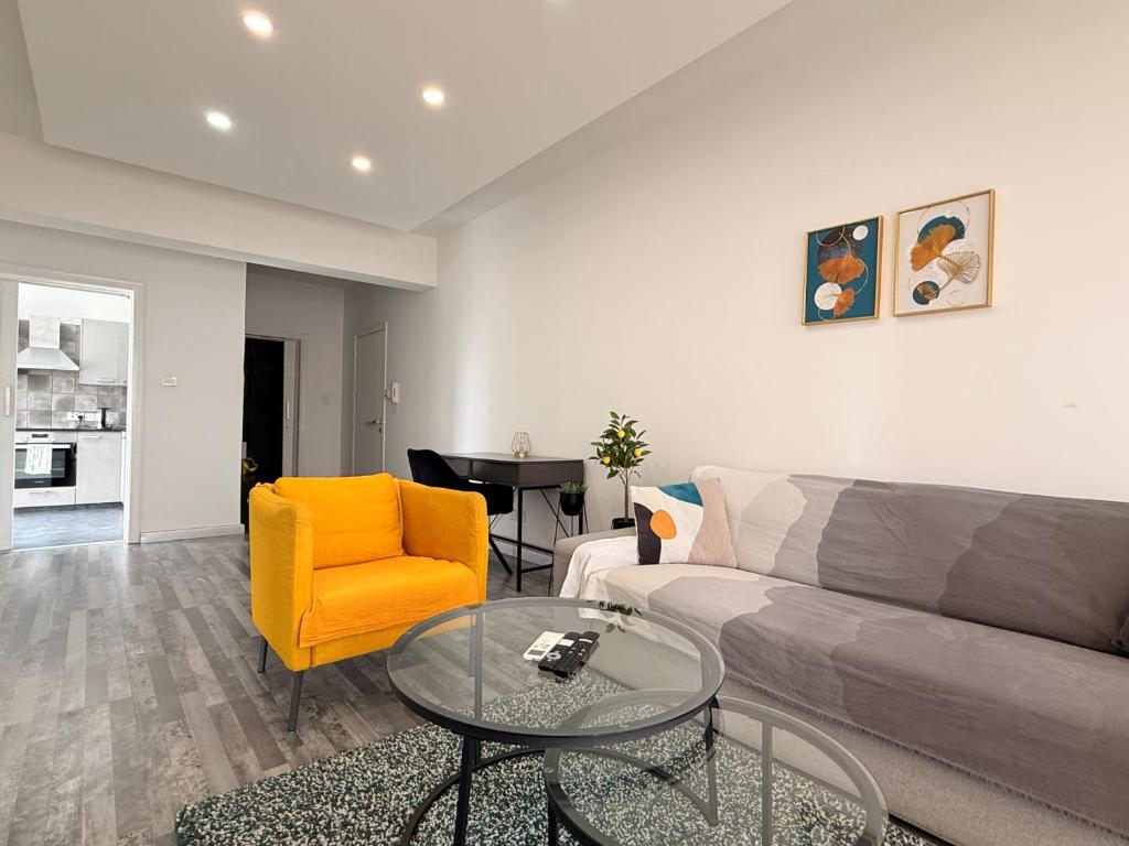 a living room with a couch and a glass table at Zinas modern flat Nicosia in Strovolos