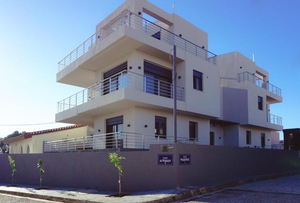 a white building with balconies on top of it at H residence 2 in Artemida