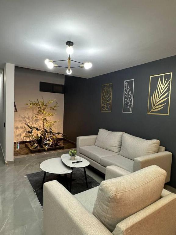 a living room with a couch and a table at AR SUITES Casa Luneta in Zamora de Hidalgo
