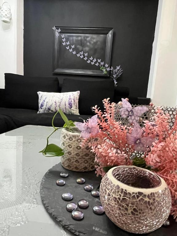a living room with two vases and a table with rocks at Lavender Home in Volos