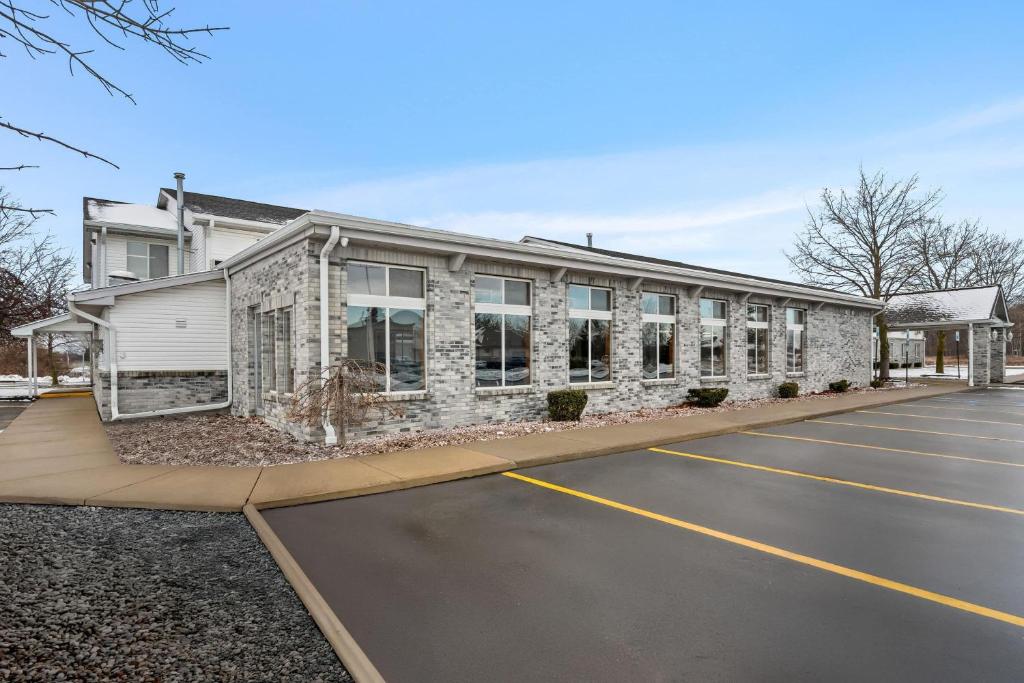 an empty parking lot in front of a building at Days Inn by Wyndham Imlay City in Imlay City