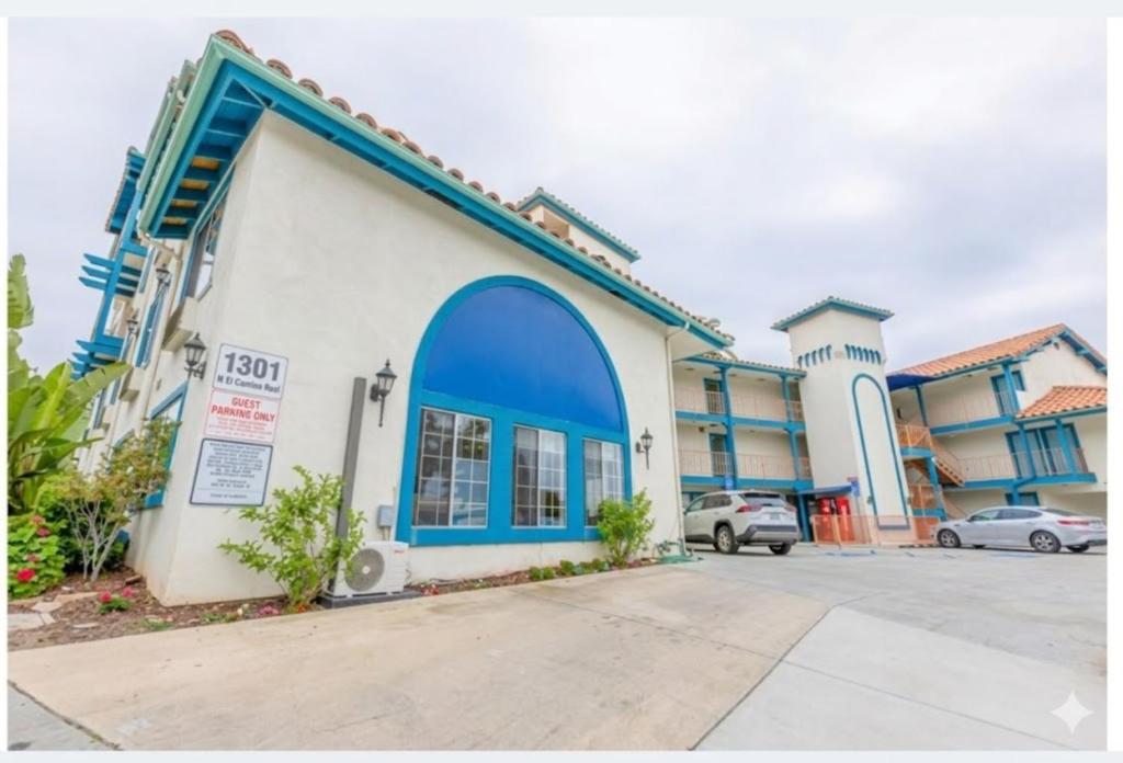 a building with a blue door in a parking lot at Hotel Avenida, San Clemente Beach in San Clemente