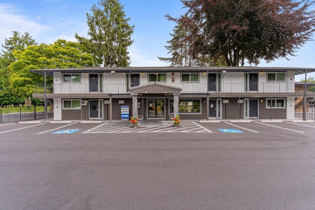 an empty parking lot in front of a building at Interurban Suites Hotel, a Dazzler Select by Wyndham in Tukwila
