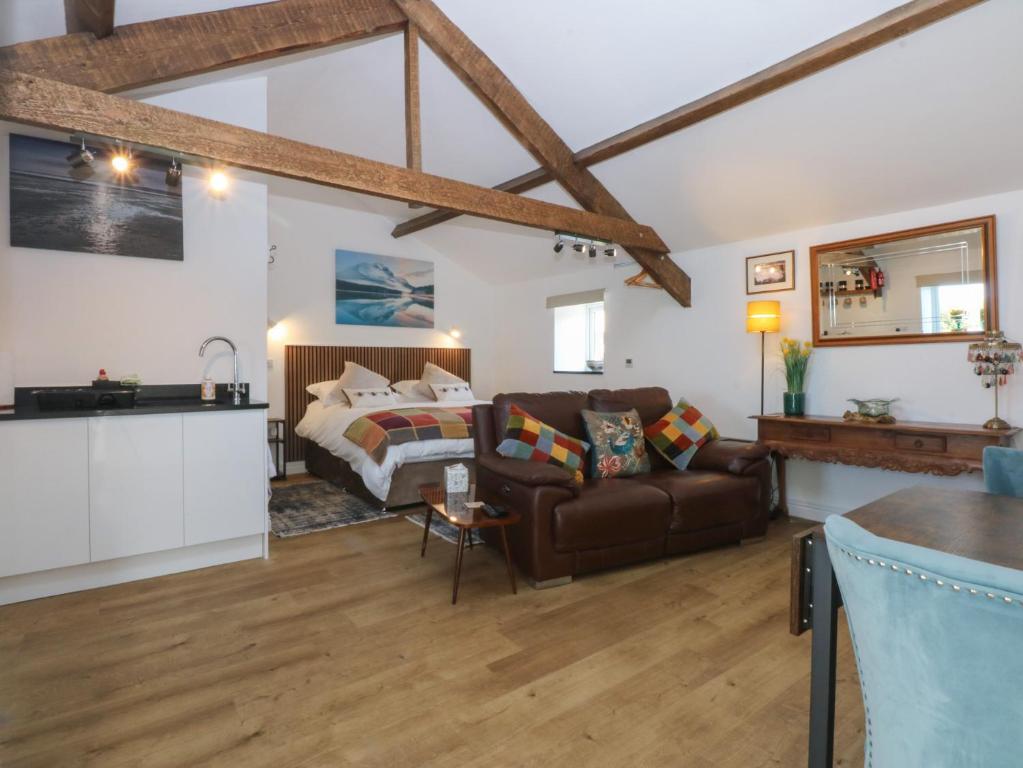 a living room with a couch and a bed at The Studio in Caernarfon