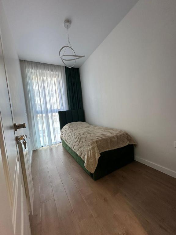 a bedroom with a bed and a large window at Wine Láà apartamento in Maison Henou