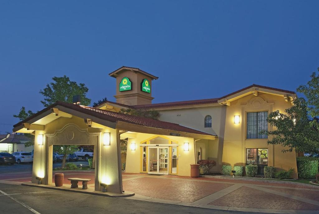 a building with a clock tower on top of it at La Quinta Inn by Wyndham Salt Lake City Midvale in Midvale