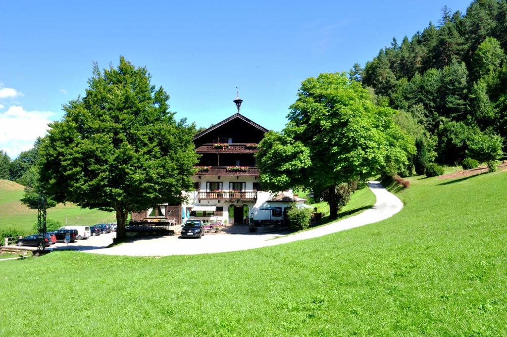 a large building in the middle of a green field at Berghotel Hinterduxerhof in Sparchen