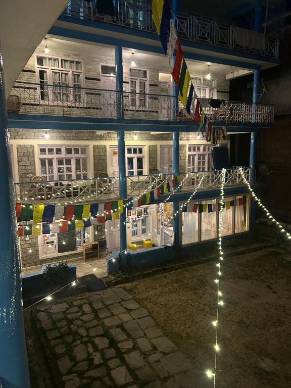 a building with chairs and flags on the side of it at MADLERS by Oakland House in Manāli