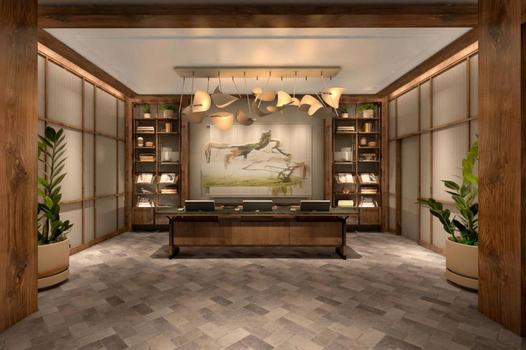 a large room with a desk and a painting of a horse at The Greenleigh, River Oaks, Autograph Collection in Houston