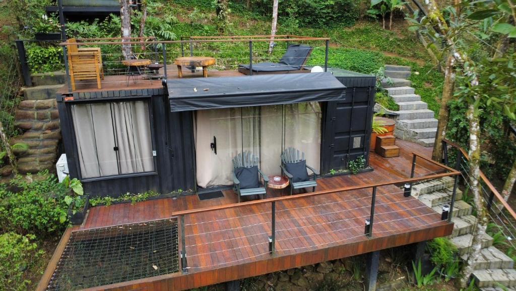 an aerial view of a tiny house with a deck at NATU Visconde de Mauá in Itatiaia