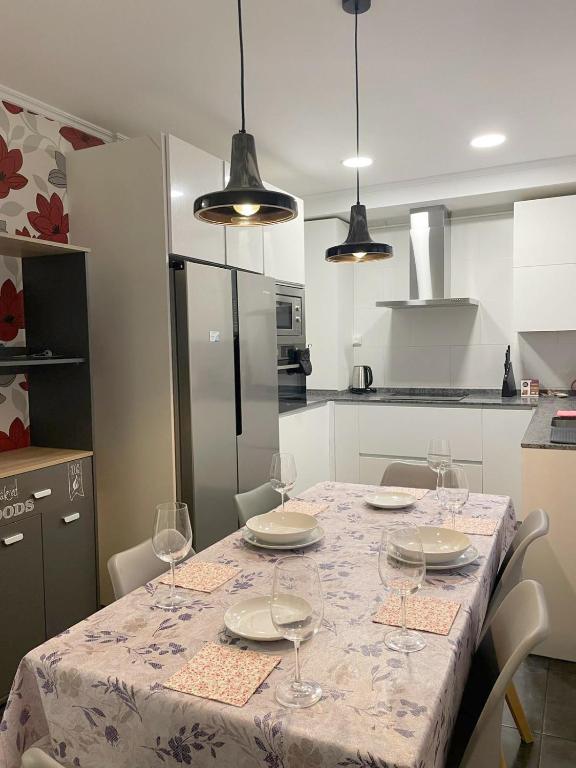 a kitchen with a table with plates and wine glasses at Apartamento Oyón in Logroño