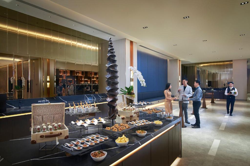 Guests browse a substantial buffet laid out in the lobby.