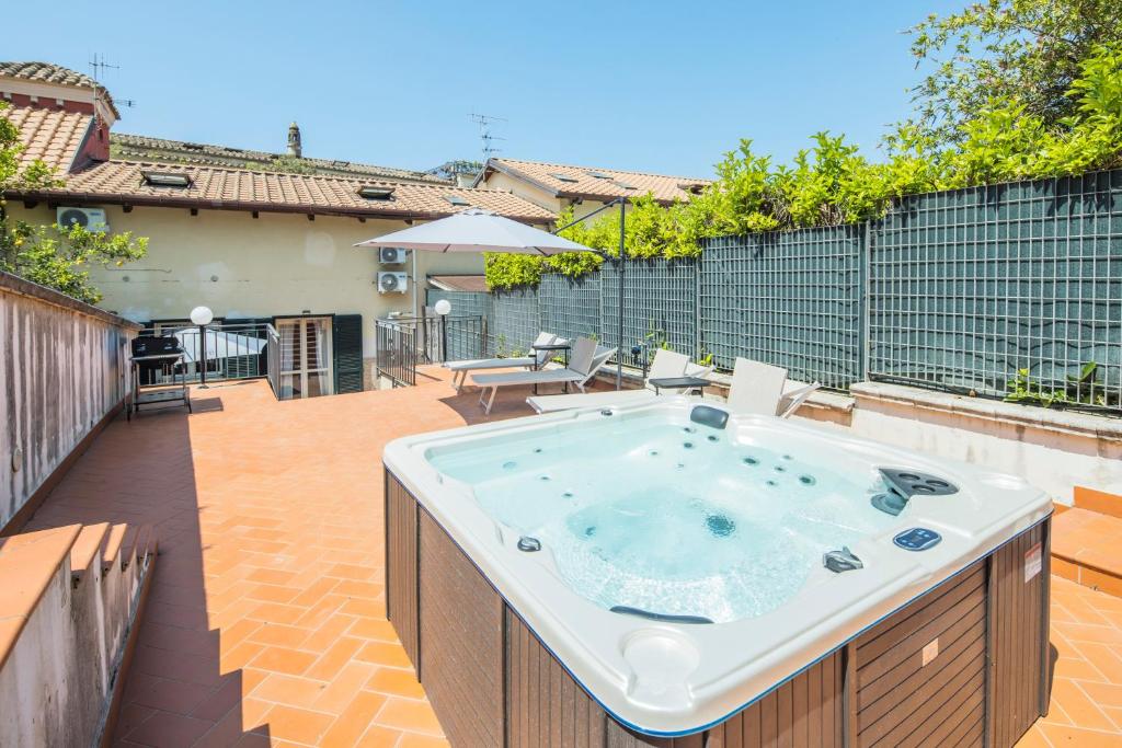 a hot tub on the patio of a house at Villa Al Borgo - Villa with Private Garden in Salerno