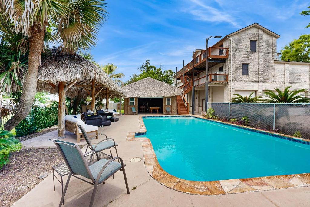 a swimming pool in front of a house at Bacliff Family Getaway w/ Game Room + Private Pool in Bacliff