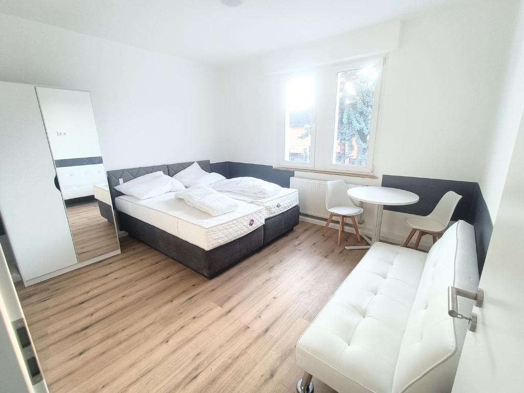 a bedroom with a bed and a table and a chair at Haus,Weinberg22 in Rüsselsheim