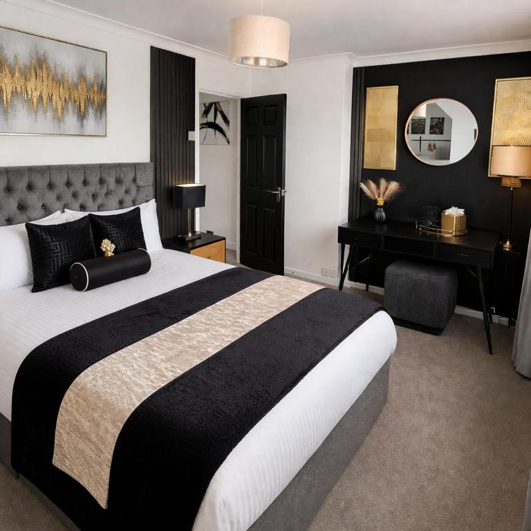 a bedroom with a large bed and a desk at Rosie House 3 bedroom House in Sandbach with Parking in Sandbach